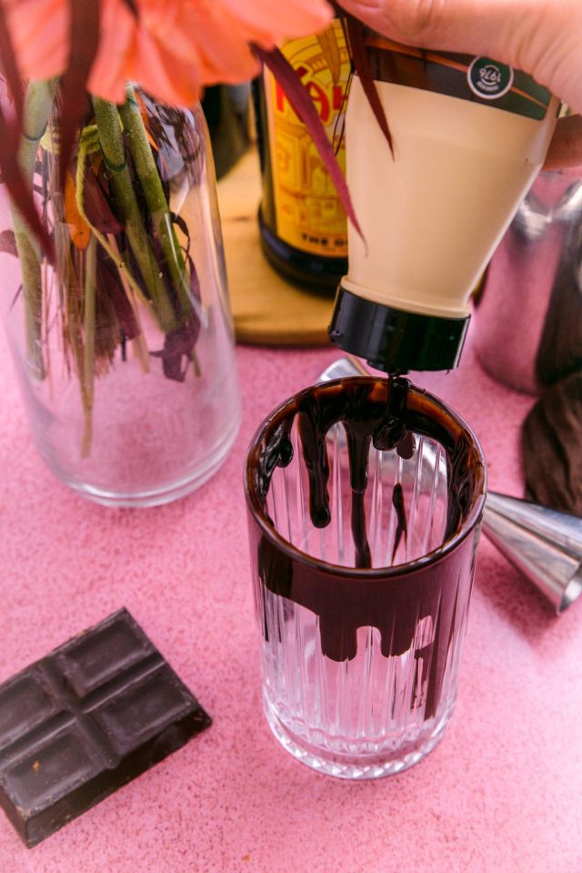 dripping the chocolate syrup to the brim of the glass